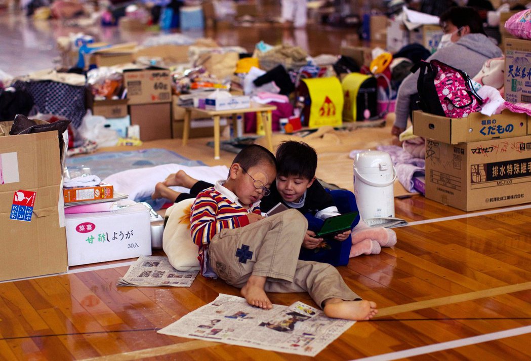 圖為2011年的311地震後，在疏散中心的小孩們。 圖／美聯社
