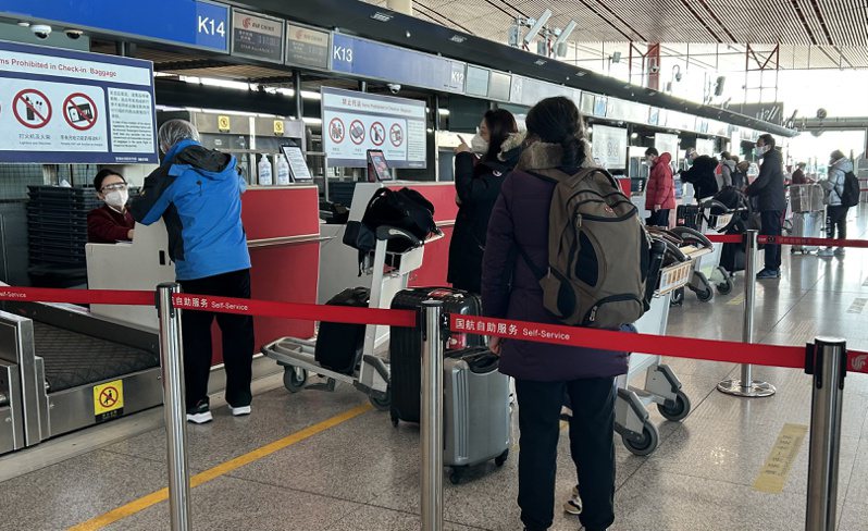 大陸明年1月8日起取消入境隔離管制，圖為近期北京首都國際機場的旅客。（中通社）