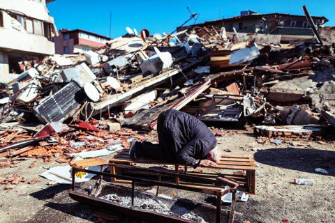 圖為哈塔伊省的倖存居民，在倒塌的房屋前跪地祈禱。 圖／歐新社