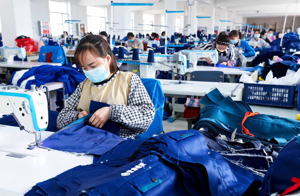 大陸經濟快速復甦，惠譽調高大陸今年GDP增長率至5%。圖為甘肅一間成衣製造廠。圖...