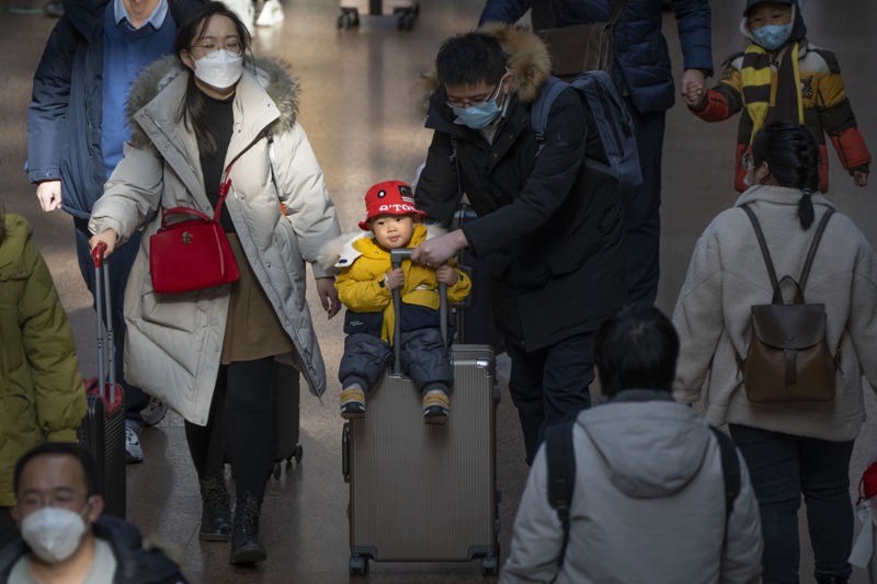 隨著中國大城市生活壓力加重，生育成本提高，「生不起」可能是許多人選擇成為「頂客家庭」的主因。圖為北京車站的返鄉夫妻。美聯社