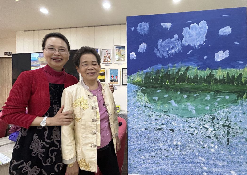 素人畫家劉秀琴（右）與作品「綠色孤島」合影。記者趙容萱／攝影