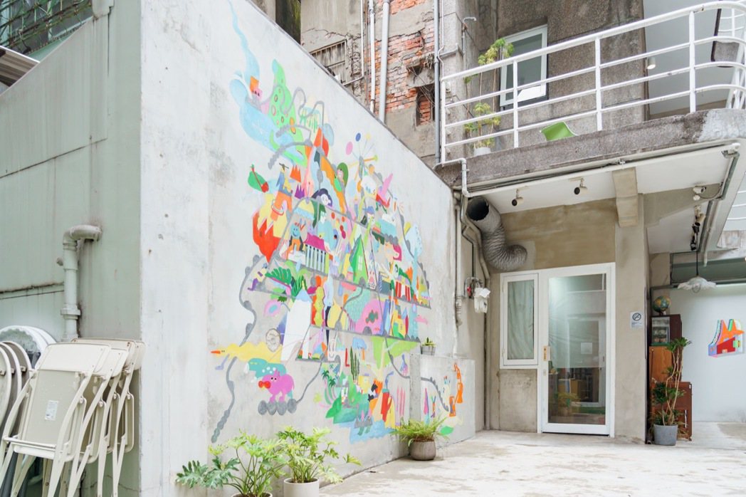 藝術家陳欣妤（Xavia）在「夾腳拖的家 花園」創立之初的中庭壁畫創作。 圖／O...