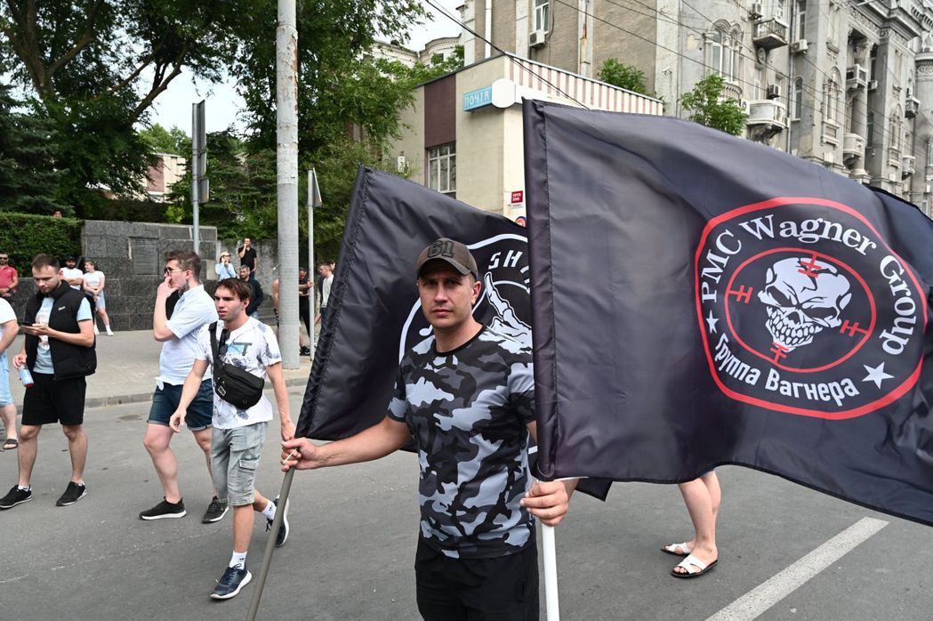 瓦格納士兵在羅淤托夫街頭發旗幟。 圖／法新社