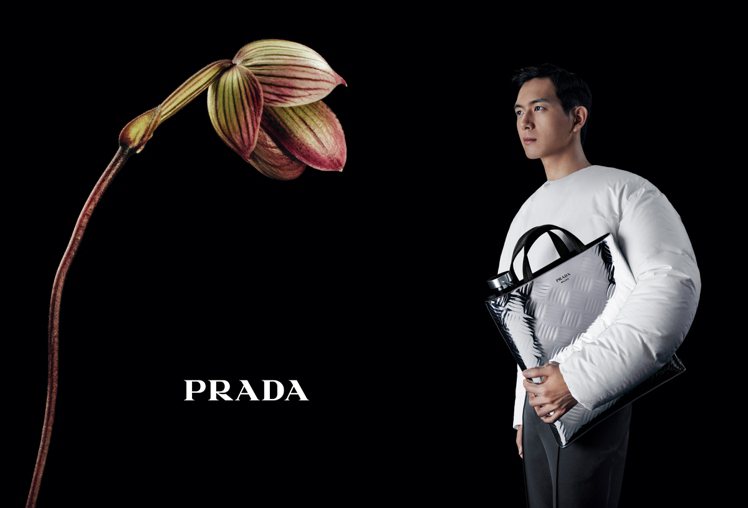 Prada代言人李望身穿白色上衣並手持金屬色亮面手提包，宛如放大版的隨身酒瓶、充滿趣味。圖／Prada提供