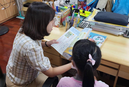 中華開發文教基金會「薪傳100×課輔100」計畫，17年來幫助超過1,700位弱勢學童。圖為薪傳志工輔導學童課業。開發金控／提供