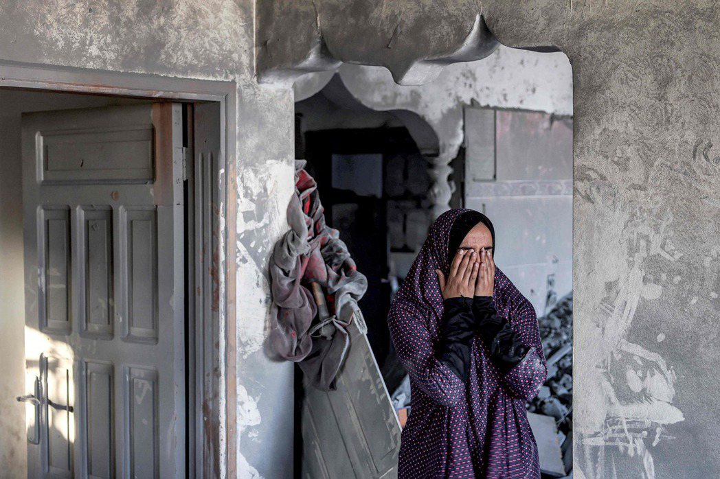 加薩南部城市拉法遭受以色列轟炸，一名女性站在被炸毀的家中無助掩面。研究顯示，承受...