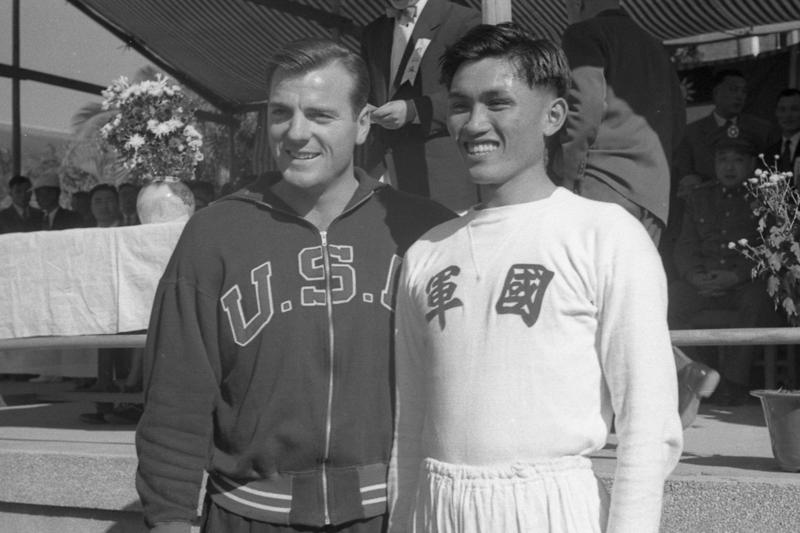 1955年12月5日，為歡迎兩屆奧運十項全能冠軍馬塞亞斯而舉行的軍民田徑示範賽，下午在師大運動場舉行，我亞運十項全能冠軍楊傳廣（右）與馬塞亞斯（左）晤面。圖／聯合報系資料照片