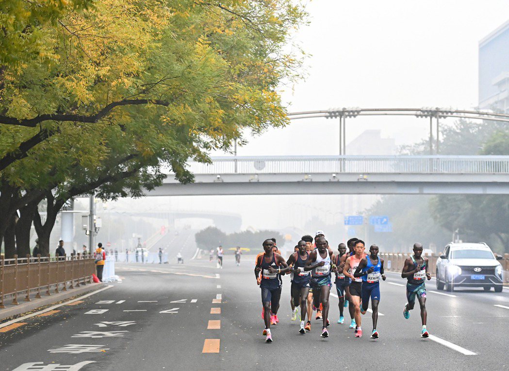 日前北京馬拉松在霧霾籠罩之下，仍照常舉行。（新華社）