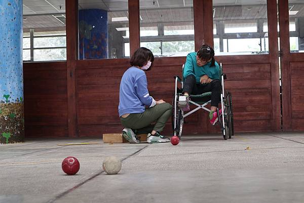 小蘭（右）愛上地板滾球運動，老師還為她特製滾球專用鞋。 圖／伊甸公關中心提供