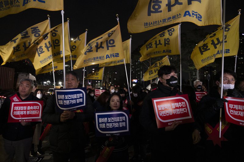 在實習醫生為抗議政府擴大招收醫學院學生而集體請辭後，南韓政府今天下令他們返回工作崗位，並正考慮使用軍醫因應人力短缺問題。圖為首爾總統府附近舉行的反對政府醫療政策的抗議活動中，抗議者高喊口號。歐新社