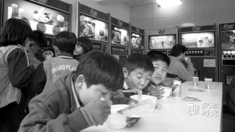 台北市新公園內自動販賣機，提供多樣食品供大家選擇，有泡麵也有熱飲等，學生吃的津津有味。(1986/02/25  本報記者攝影)