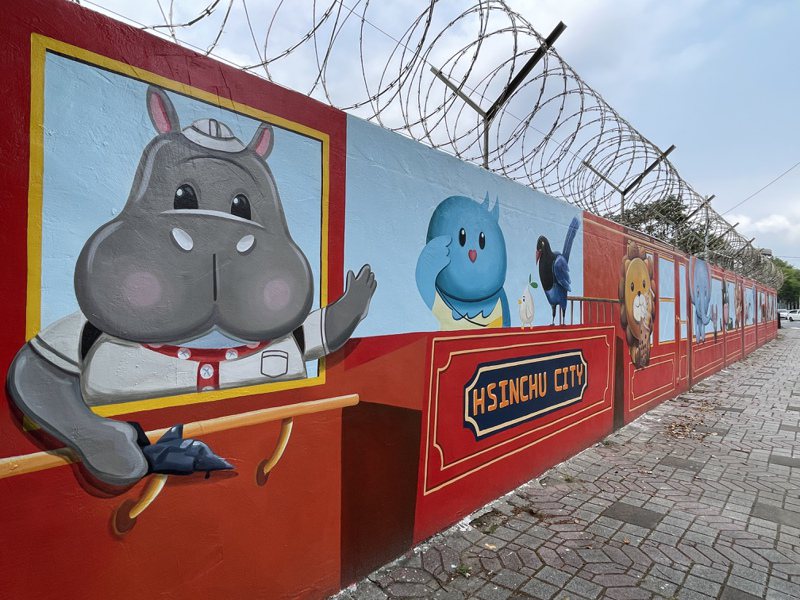新竹市空军基地旁靠成功路围墙最近完成一大片彩绘，画上新竹市吉祥物河马乐乐与喜鹊皮卡。记者张裕珍／摄影