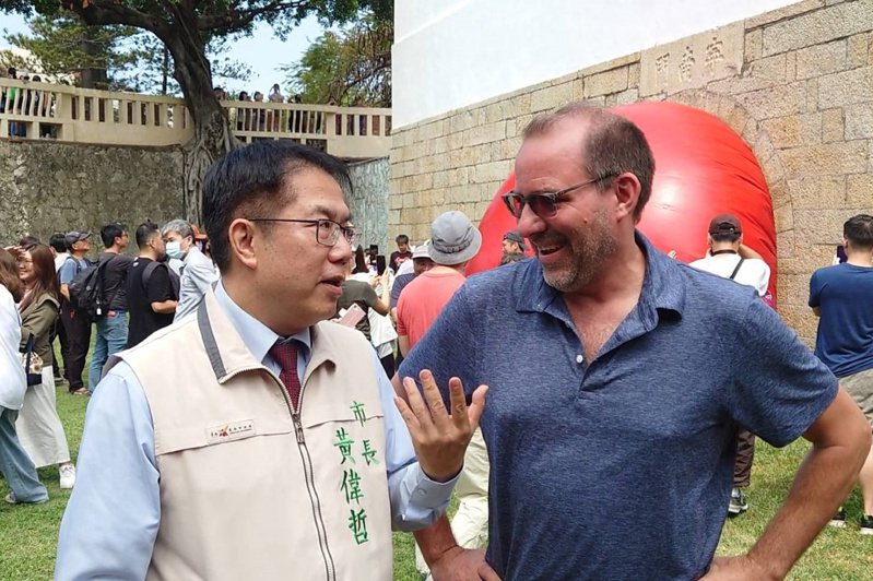 红球台南历史街区策展行动最终站7日在古迹大南门城登场，台南市长黄伟哲（前左）到场，向发起「红球计划」的美国艺术家波希克（Kurt Perschke）（前右）致意。中央社