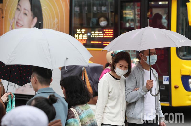 台北市下午有零星短暫雨，許多逛街民眾偶有撐傘，不過明天氣溫將比今天高，天氣也回穩。記者潘俊宏／攝影