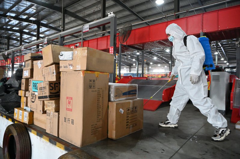 衛生防護中心公布一個來自內蒙的包裹外包裝驗出對新冠病毒呈陽性。圖為11日「雙11」購物節當日，內蒙古呼和浩特一個快遞物流園內，工作人員消毒快件。（中新社）