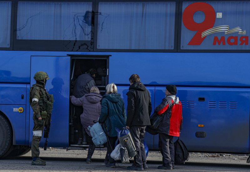烏克蘭官方7日稱，被困在馬里波亞速鋼廠的所有婦孺老人都已撤出。圖為撤出的平民在俄軍士兵監視下搭乘巴士離開。(歐新社)