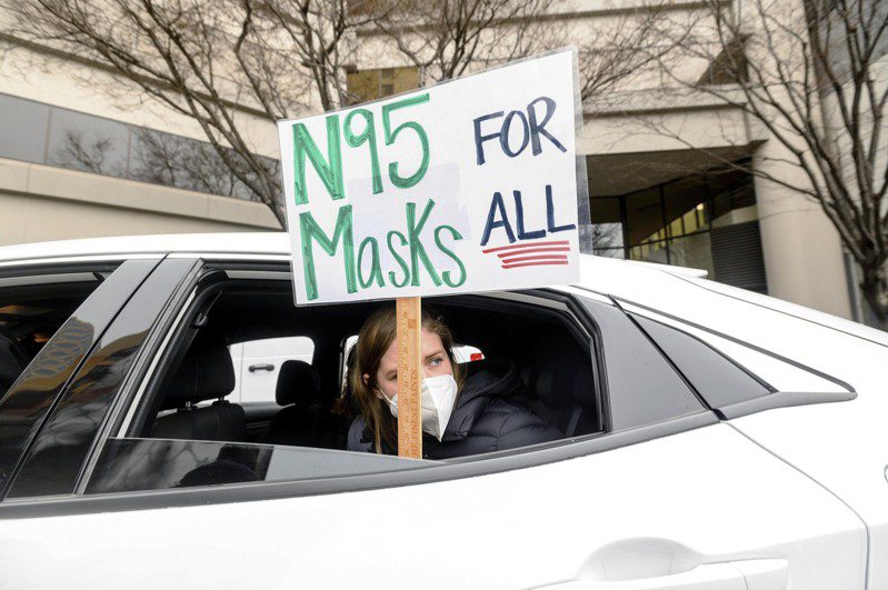 一名住在奧克蘭的小學教師示威抗議，認為應廣為派發N95口罩。(美聯社)