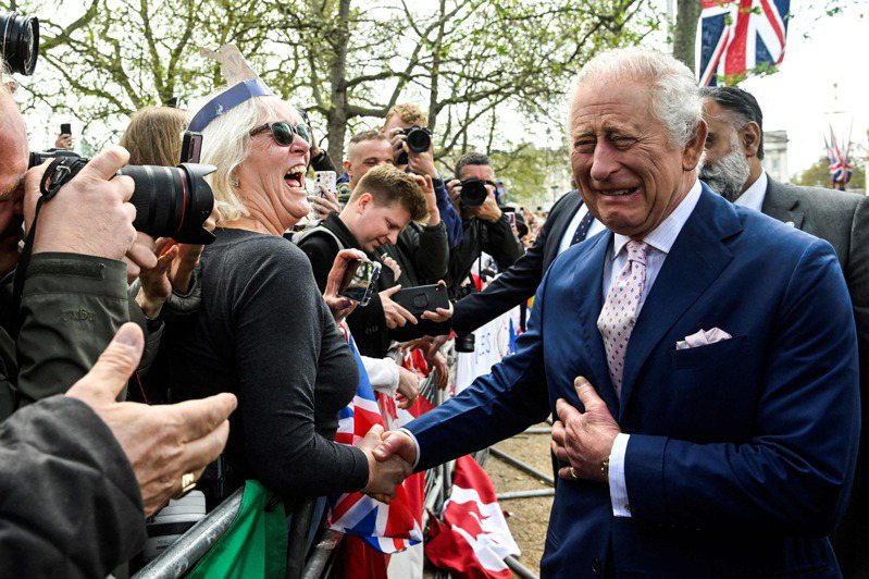 英國時隔70年，今天（6日）將為國王查理三世及王后卡蜜拉舉行加冕大典。查理國王5日與白金漢宮外的熱情民眾握手。（Getty Images)