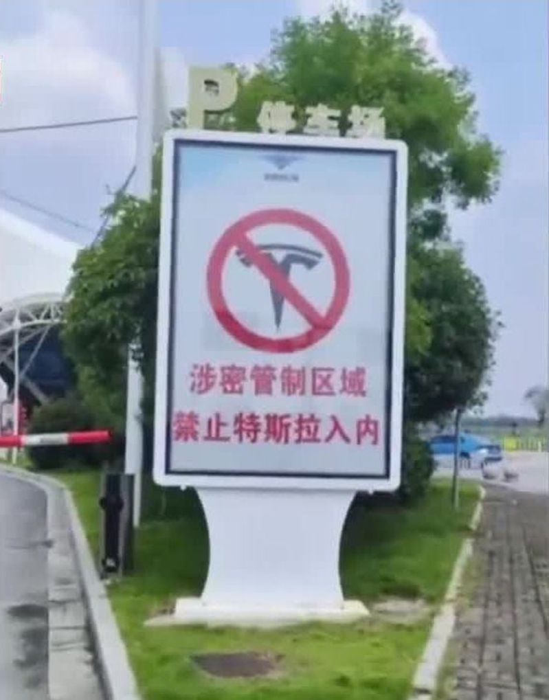 在湖南岳陽三荷機場的停車場立有告示，寫著「涉密管制區域，禁止特斯拉（Tesla）入內」。（取材自微博）